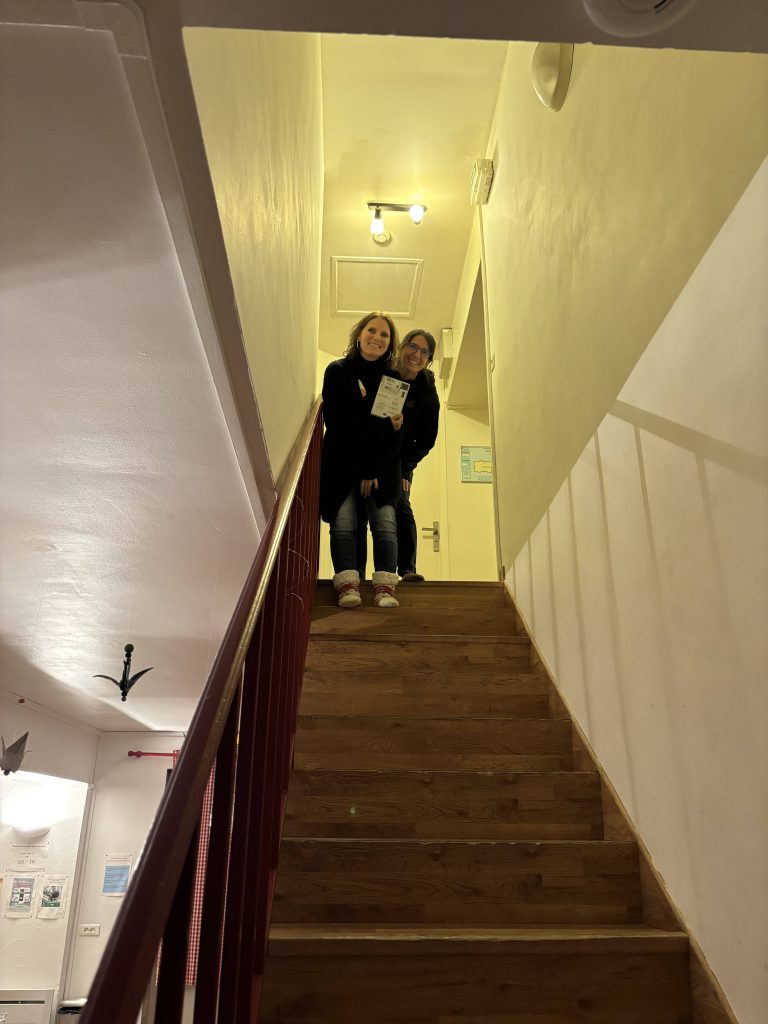 Deux participantes souriantes dans l'escalier de La Bergerie à Brie, lieu du week-end scrapbooking 2026